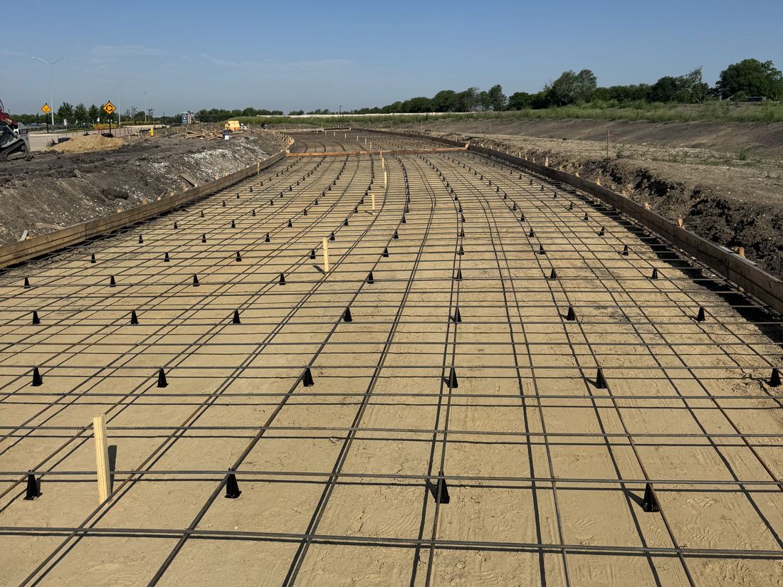 Rebar grid set on chairs over a prepared base before a pour