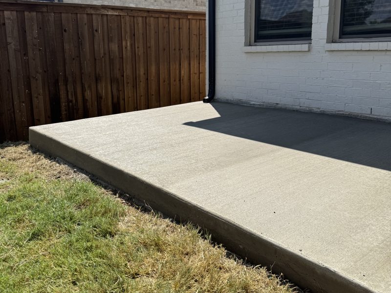 Finished patio slab along the fence