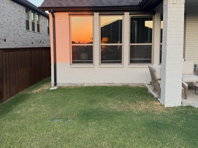 Grassy corner beside the covered patio, before